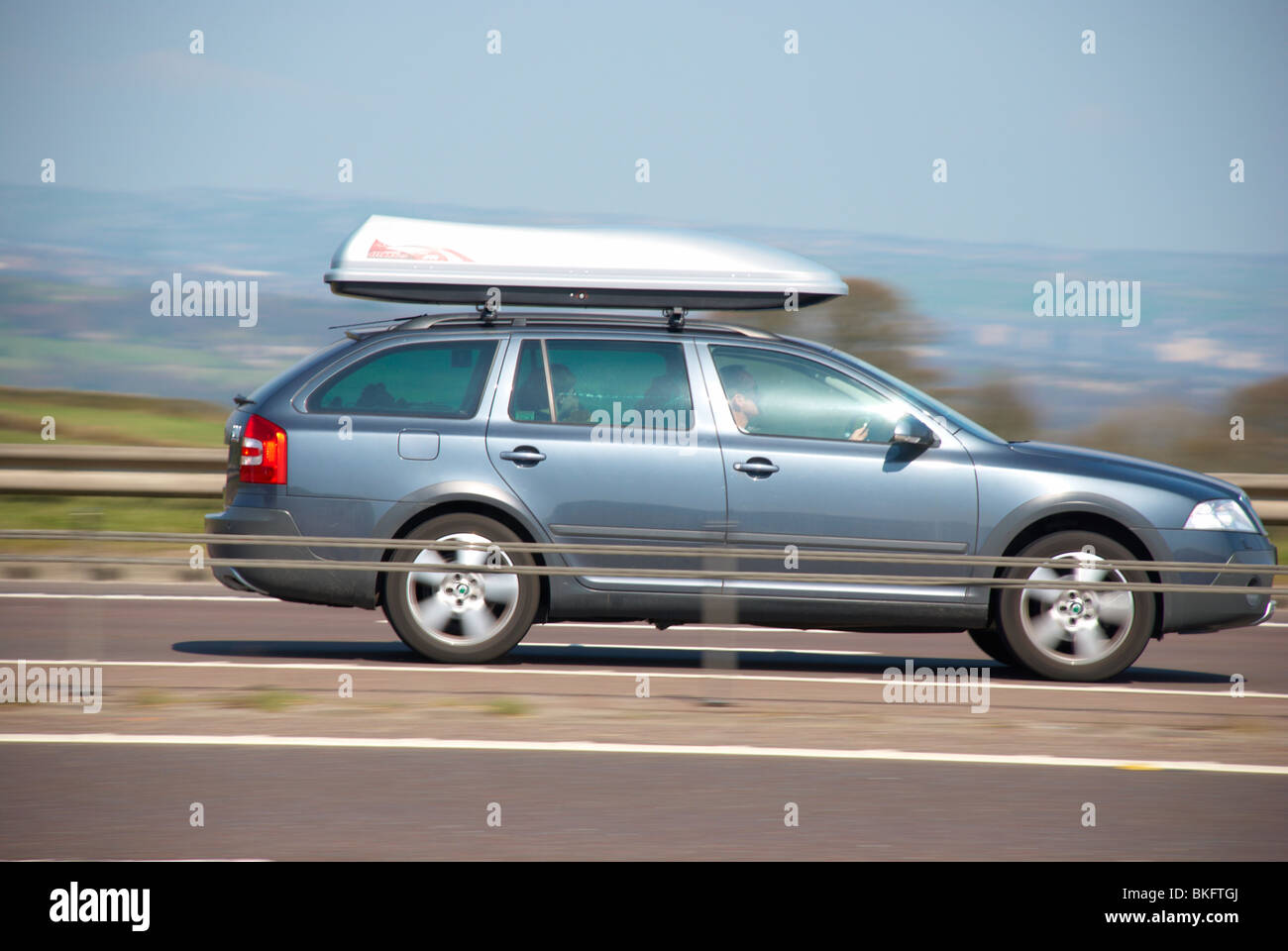 Silver / blue Skoda estate car (with roof boot) on the M62 motorway (near Outlane, Huddersfield). Stock Photo