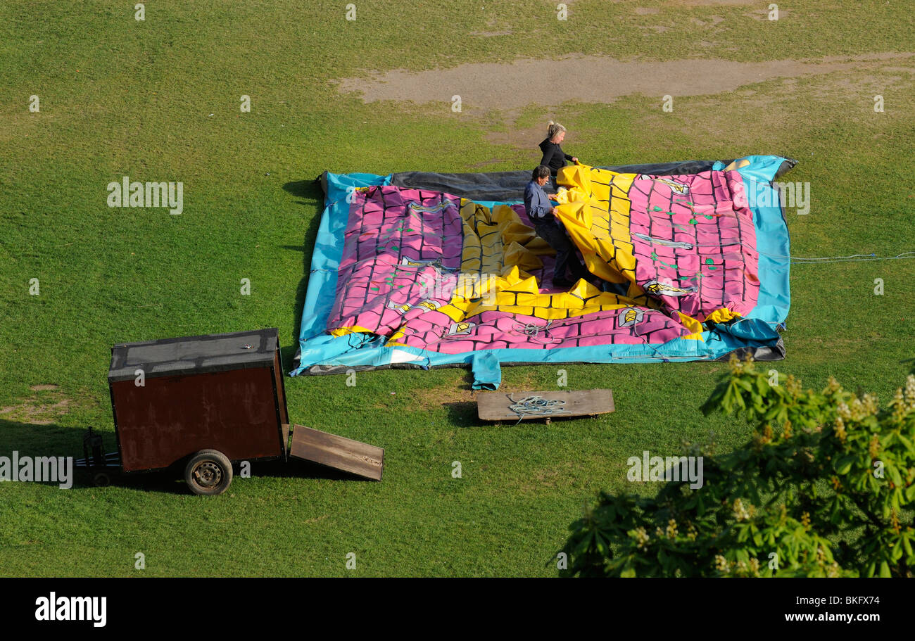 Bouncy Castle being folded away after use in a Plymouth park Devon England UK Stock Photo