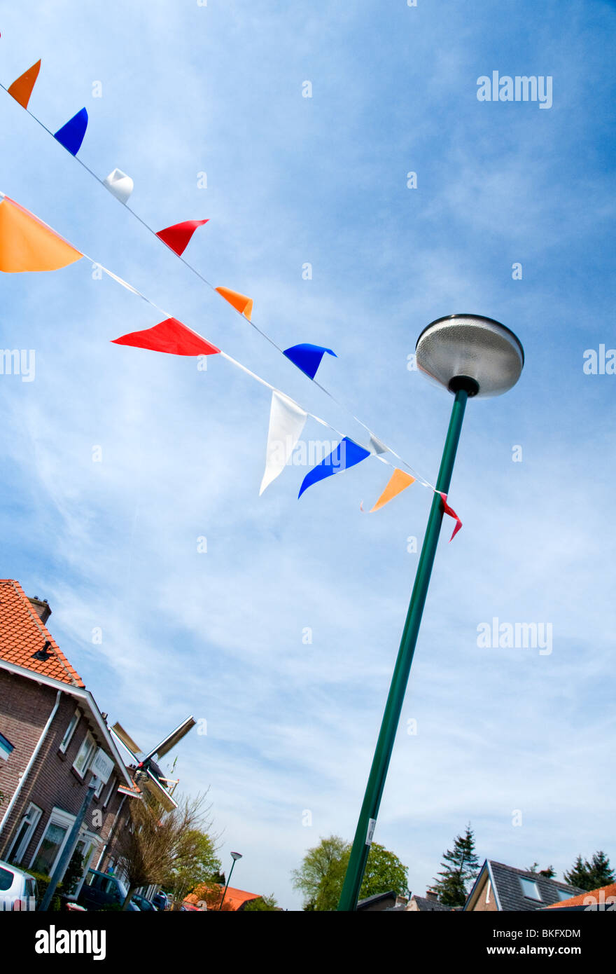 A street in the Dutch town of Veenendaal decorated with bunting in celebration of  the King's Day holiday on April 27 Stock Photo