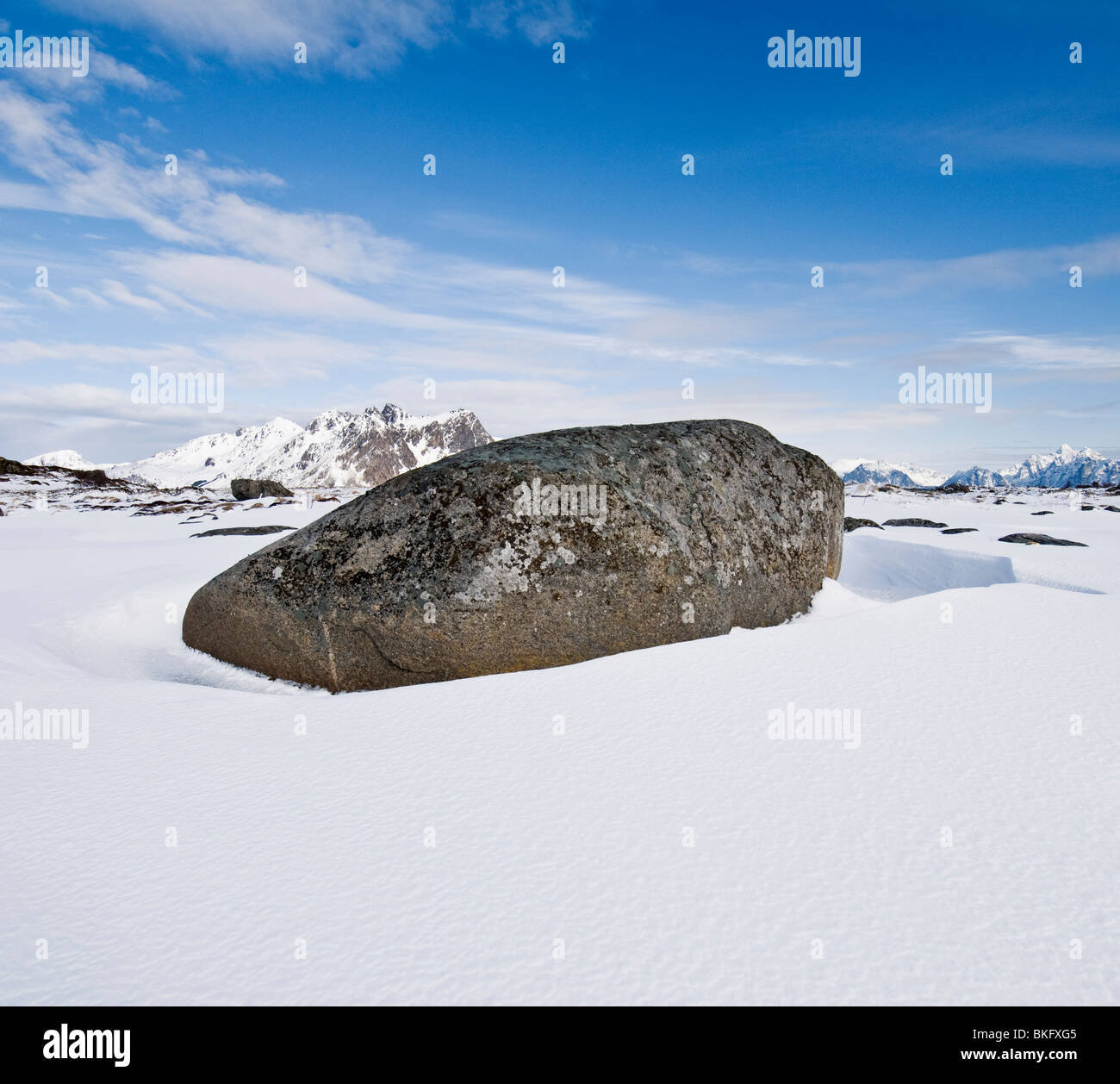 Large boulder in snow covered winter landscape, Near Stamsund, Vestvågøy, Lofoten islands, Norway Stock Photo