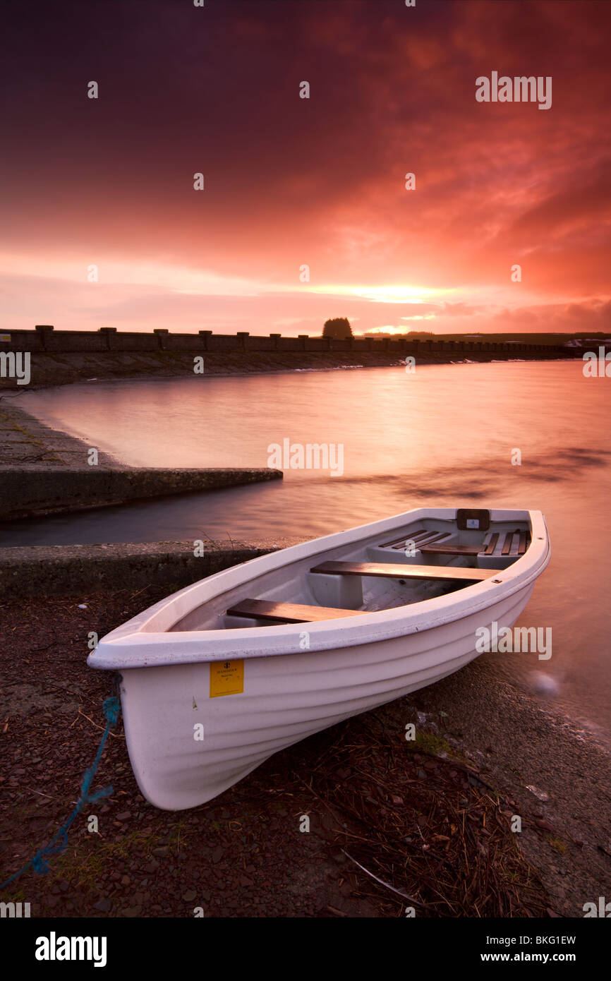 Fishing boat tethered on the shores of the Usk Reservoir at sunrise, Brecon Beacons National Park, Wales, UK. Stock Photo