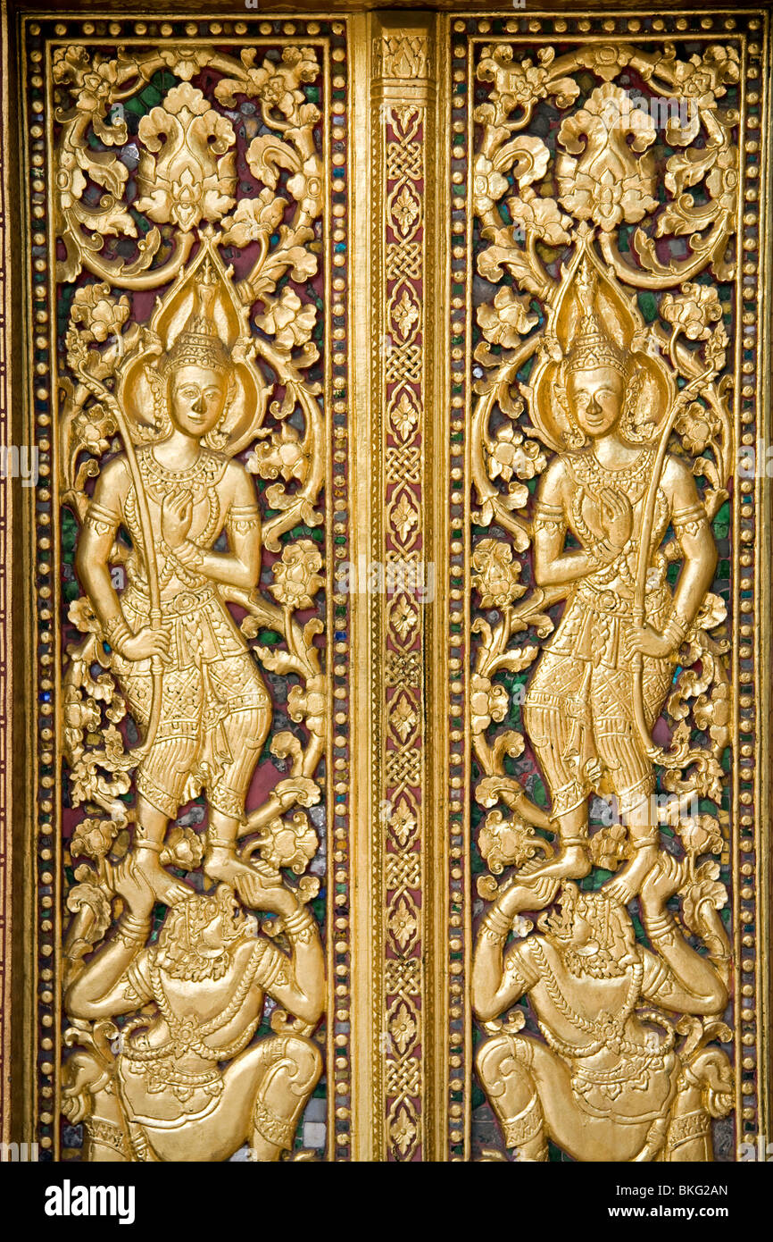 Elaborate wood carvings on Wat Saen's entrance door, Luang Prabang, Laos Stock Photo