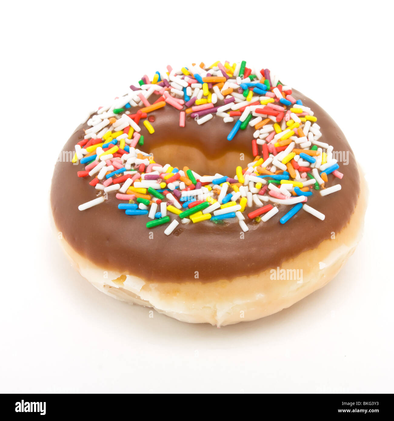 Chocolate Doughnut with vibrant multicoloured sprinkles isolated against white. Stock Photo