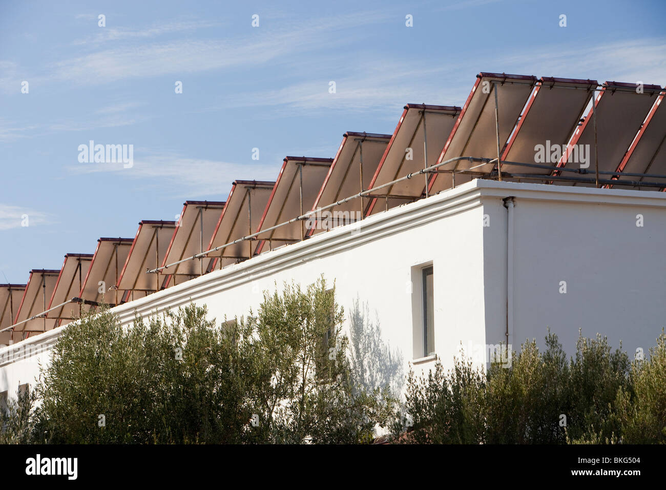 Solar water heating panels on the roof of a launderette in Teos, Western Turkey. Stock Photo
