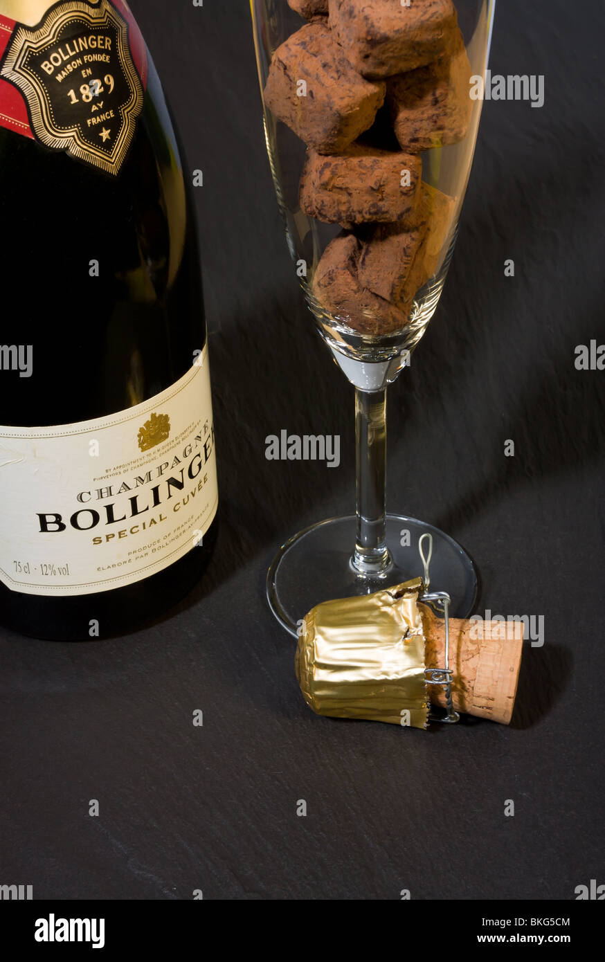 Champagne truffles in flute and Vintage Bollinger Champagne Bottle Stock Photo