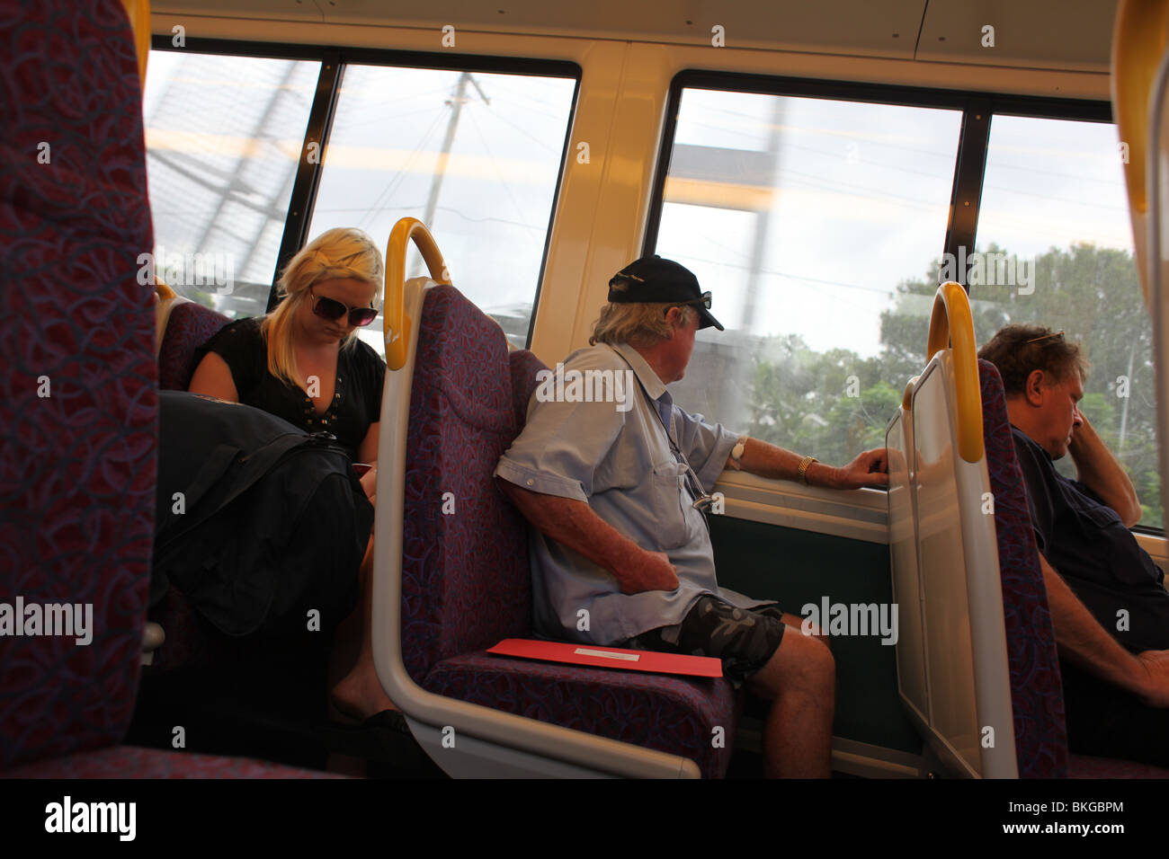 People on the train from Brisbane to Gold Coast, Australia Stock Photo