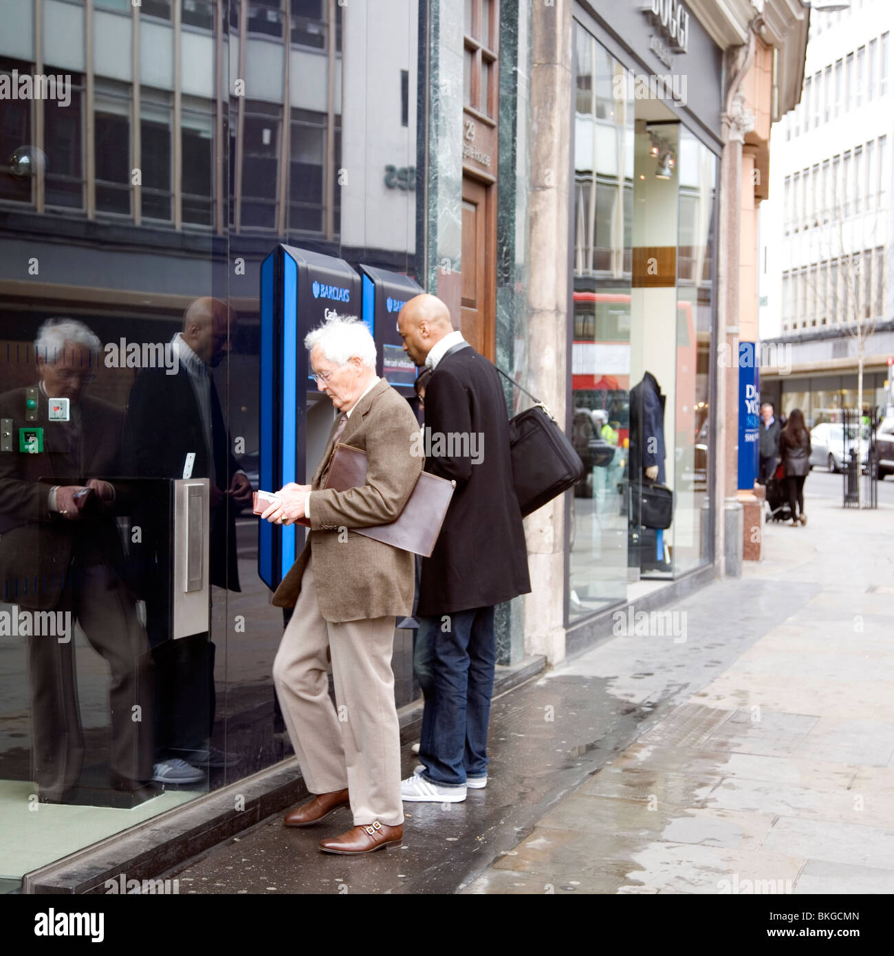 Withdrawing cash at Barclays ATM Sloane Square Stock Photo Alamy