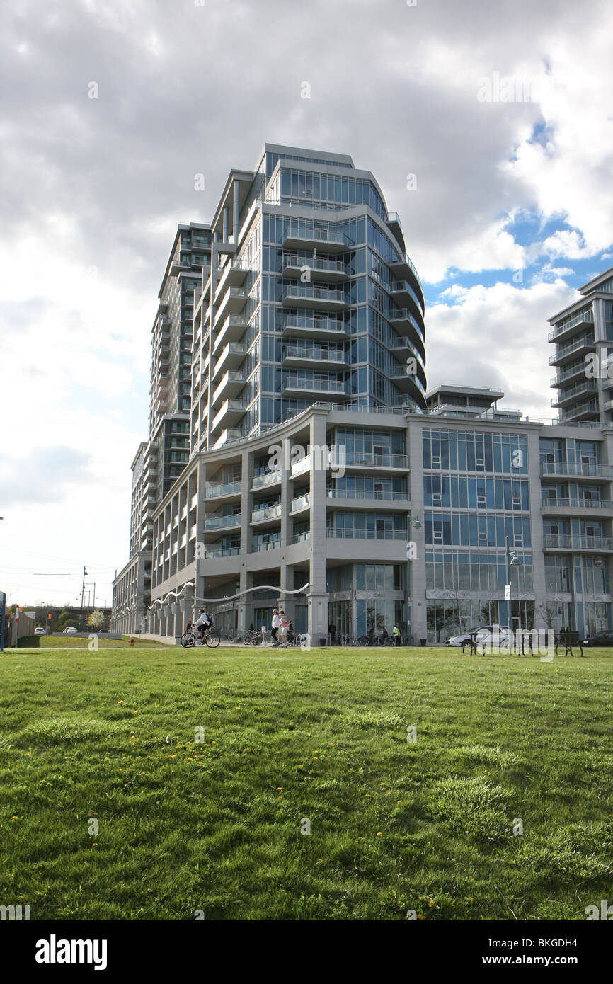 condo apartment building green blue sky modern city life residential Stock Photo