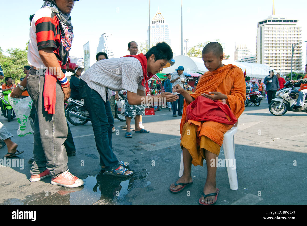 Novice monk blessing. Red Shirt protesters occupy the shopping district of Central Bangkok. Stock Photo