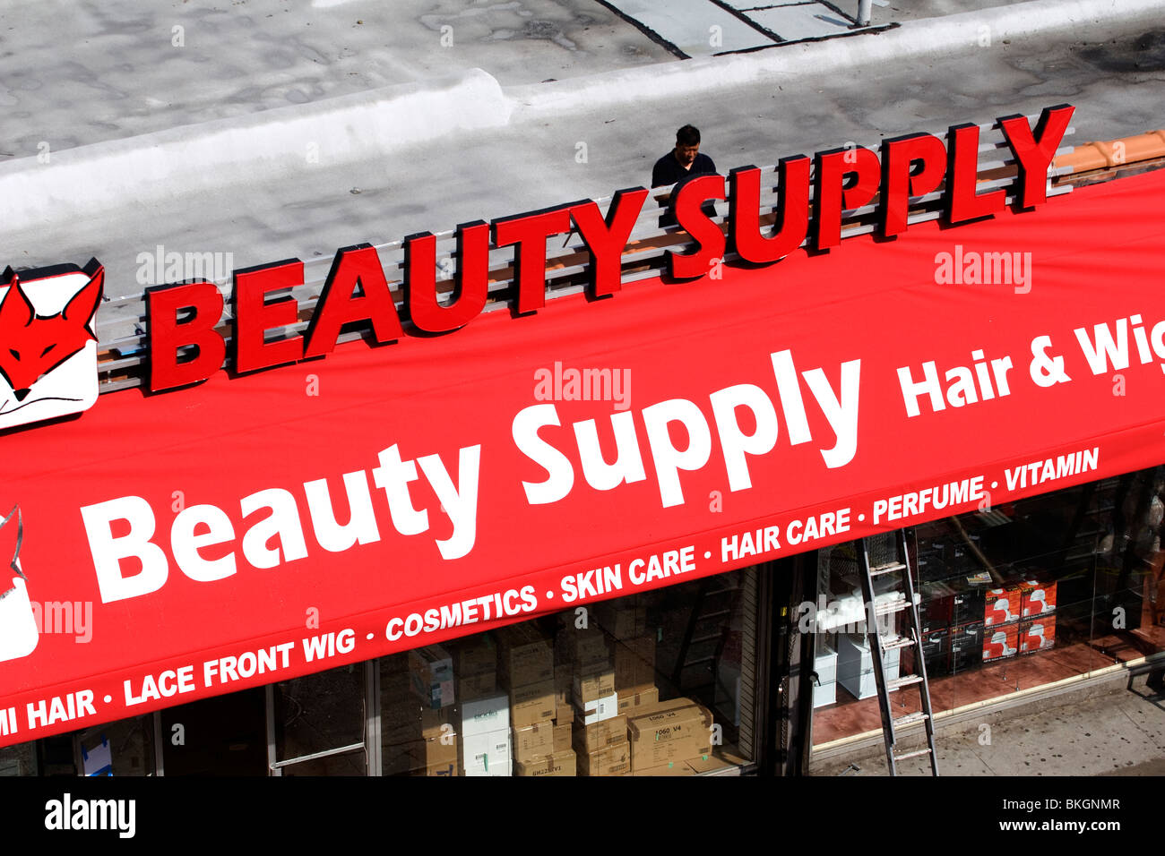 installing new sign on new business on Nostrand Avenue in Flatbush, Brooklyn, NYC Stock Photo
