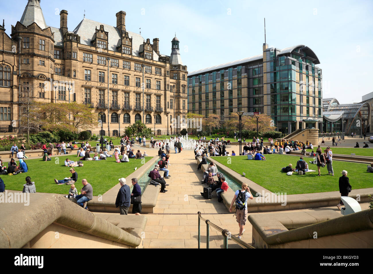 People enjoying the Peace Gardens by the Town Hall and The Mercure Sheffield St Paul's Hotel, Sheffield, South Yorkshire, England, UK. Stock Photo