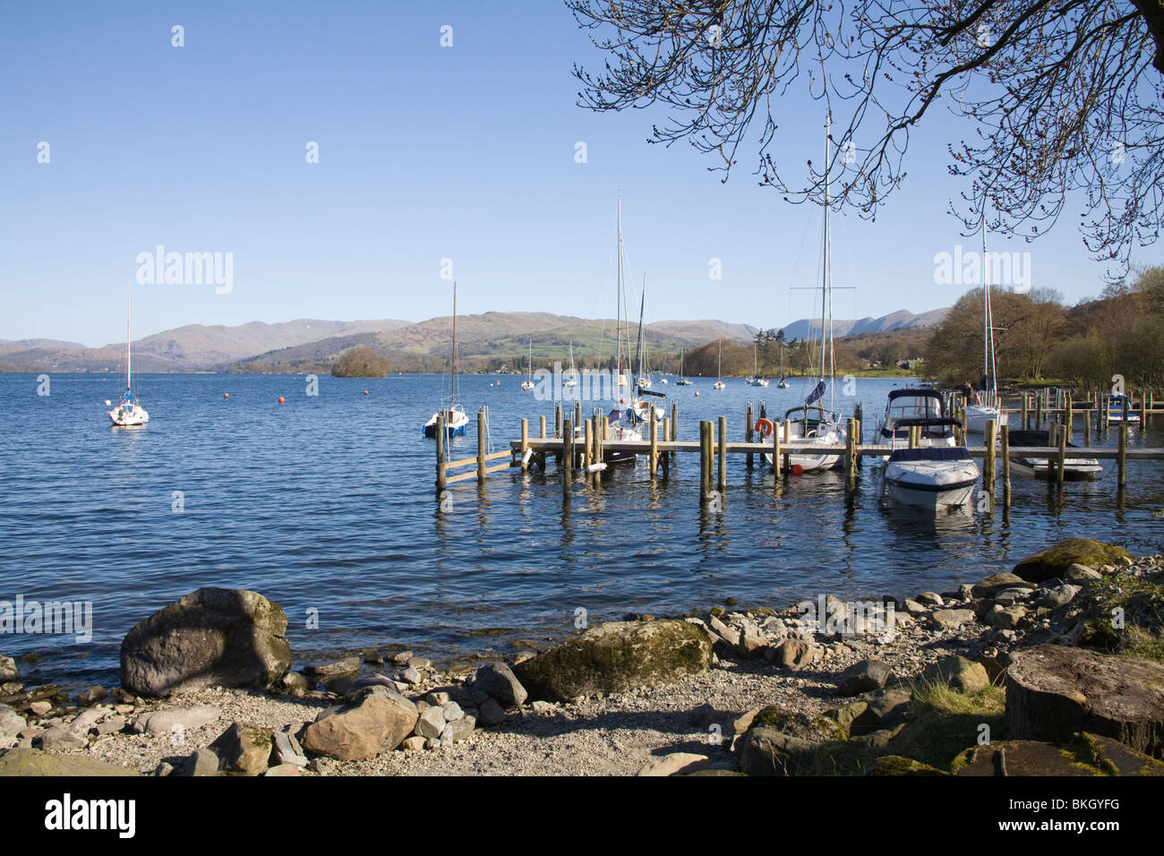 Lake District Cumbria UK April Looking across yachts moored on Lake Windermere towards Loughrigg Fell Stock Photo