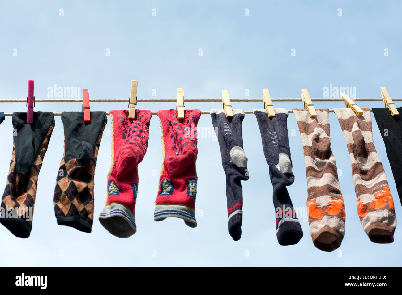 Row of socks drying on washing line in Burano Italy Stock Photo