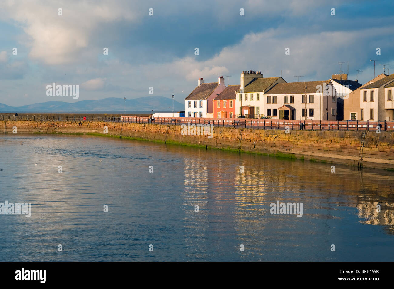 The harbour at Maryport, Cumbria, looking across the Solway Firth to the hills of Galloway in Scotland Stock Photo