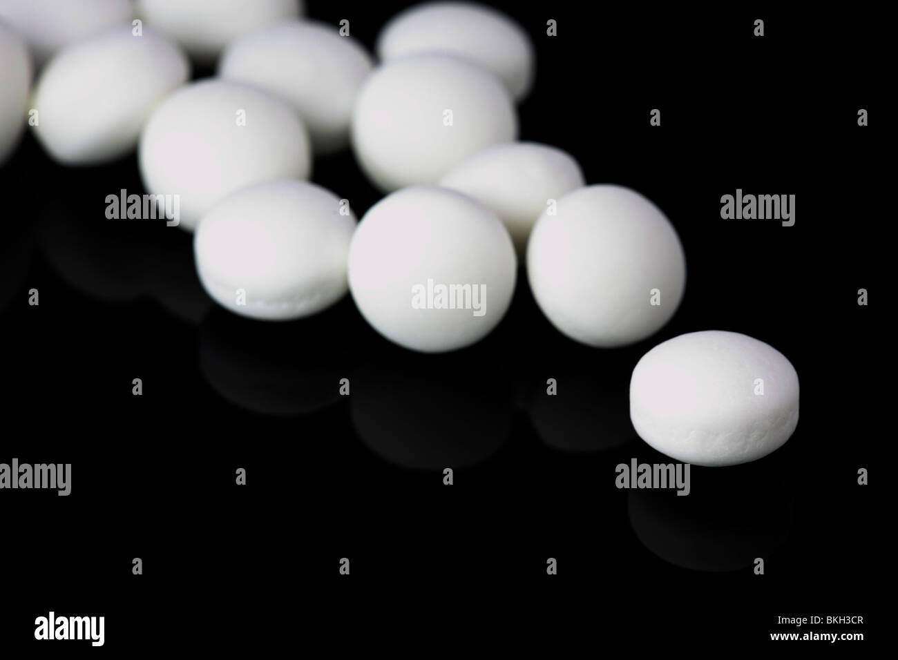 Imperial mints on a black reflective background Stock Photo