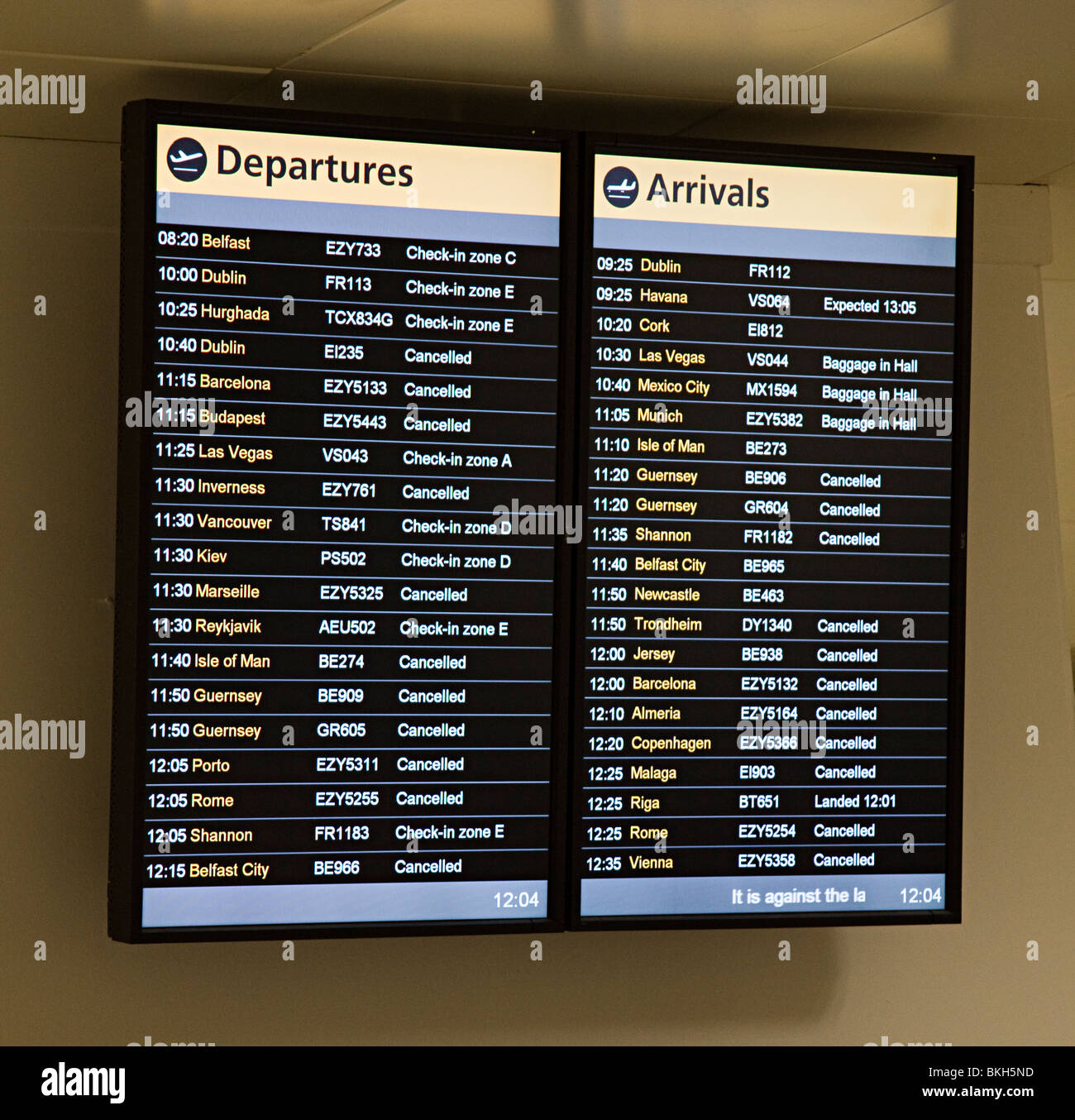 Departures and Arrivals board showing flights cancelled due to volcanic ash in the air Gatwick airport England UK Stock Photo