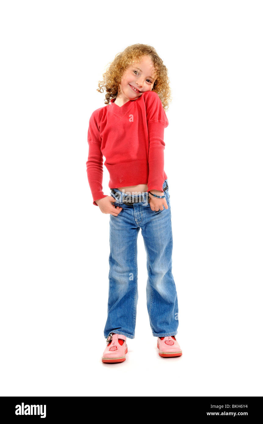 Six year old girl wearing blue jeans & a red shirt with sandals poses for  the camera against a plain white background Stock Photo - Alamy