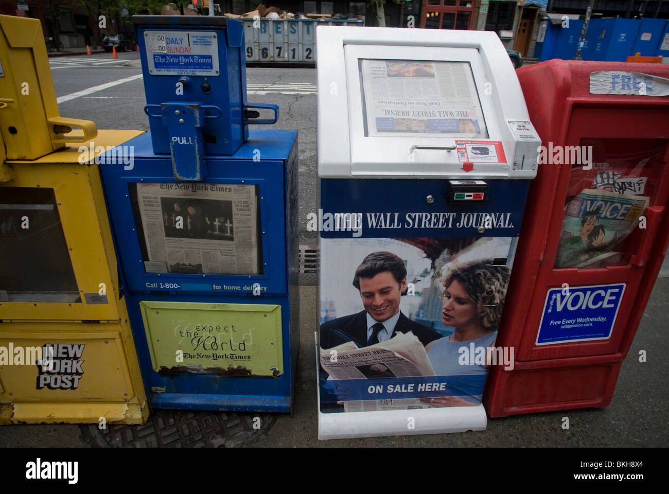 Wall Street Journal and New York Times newspaper distribution boxes are seen side by side in New