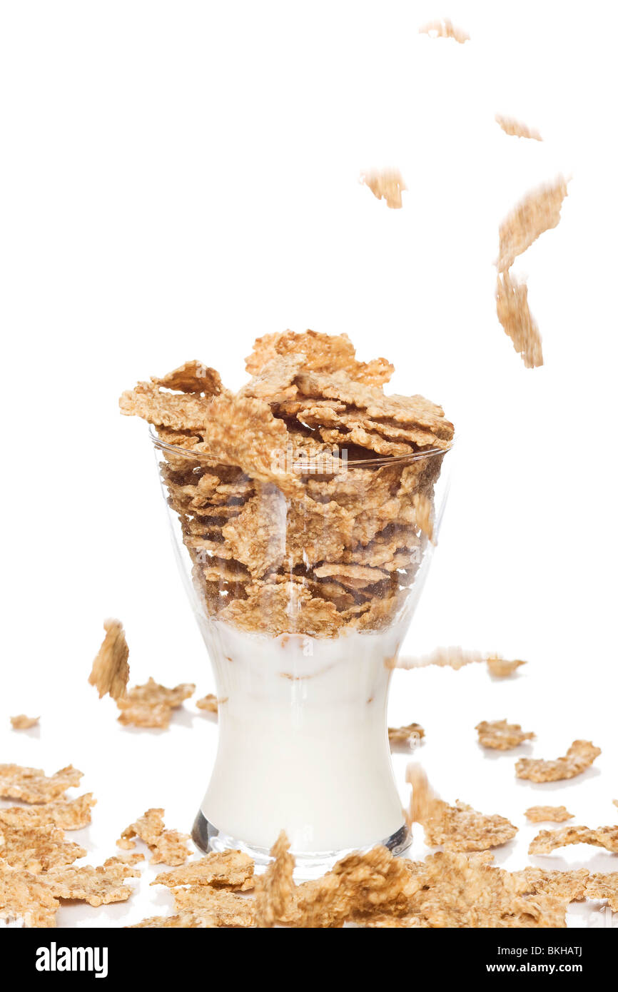 Corn flakes, muesli flying in to glass of milk Stock Photo Alamy