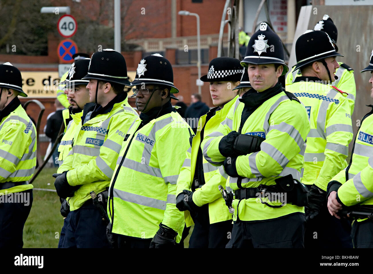 riot police at the edl demo in dudley uk against the building of a mosque with a black officer standing amongst white ones Stock Photo