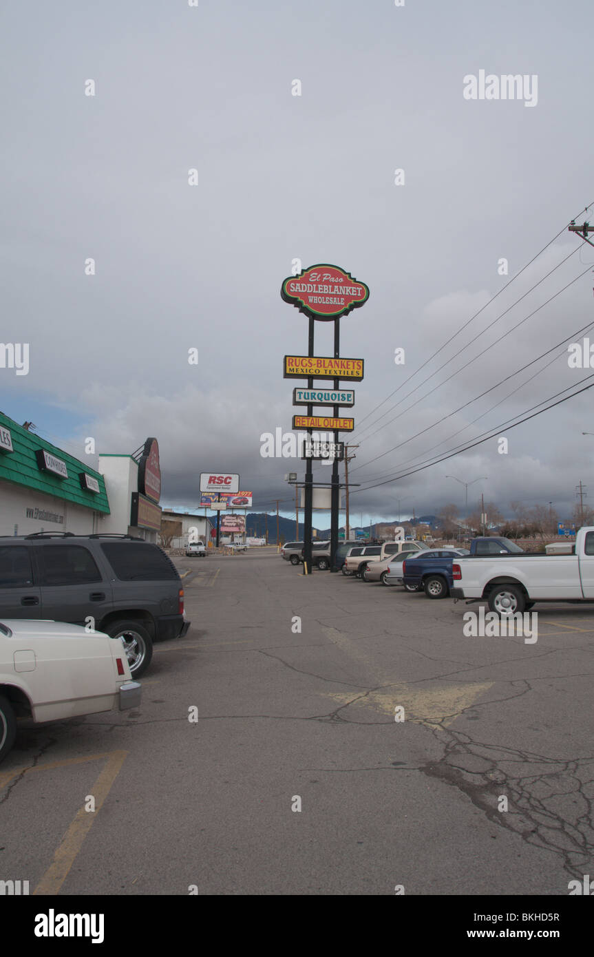 Heavy thunder skies over the sign of Saddle Blanket, El Paso's most