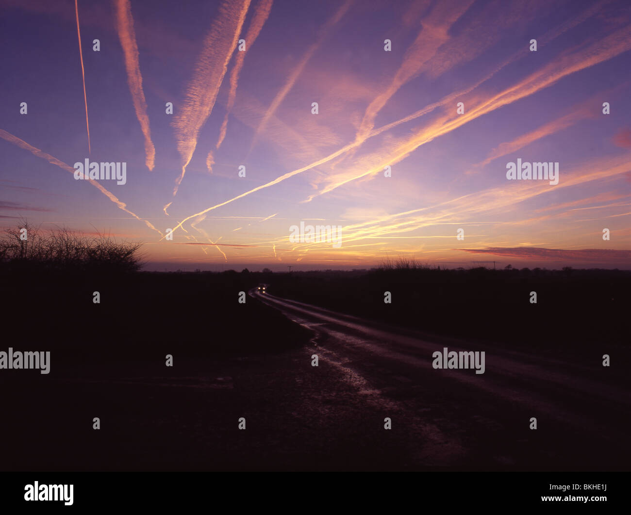 Morning vapour trails over north Norfolk as airliners flying overnight from North America arrive in Europe. Stock Photo