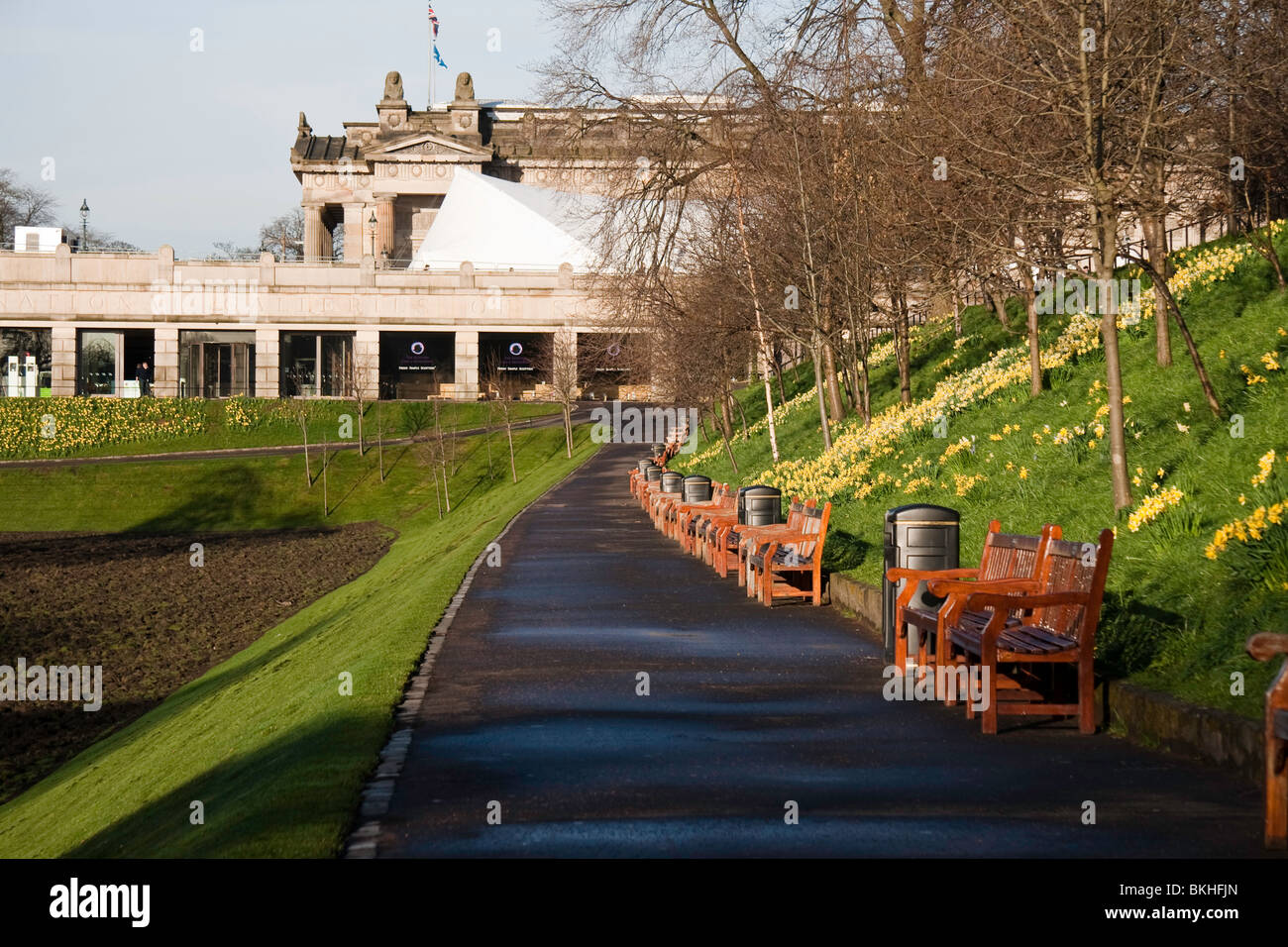 A benchlined path in Edinburgh's Princes Street Gardens on a bright