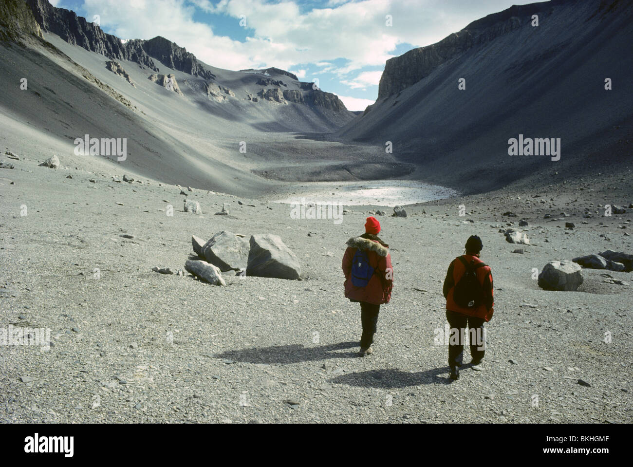 Antarctica, Victoria Land, Wright Dry Valley,  biologists hiking towards Don Juan Pond. Stock Photo