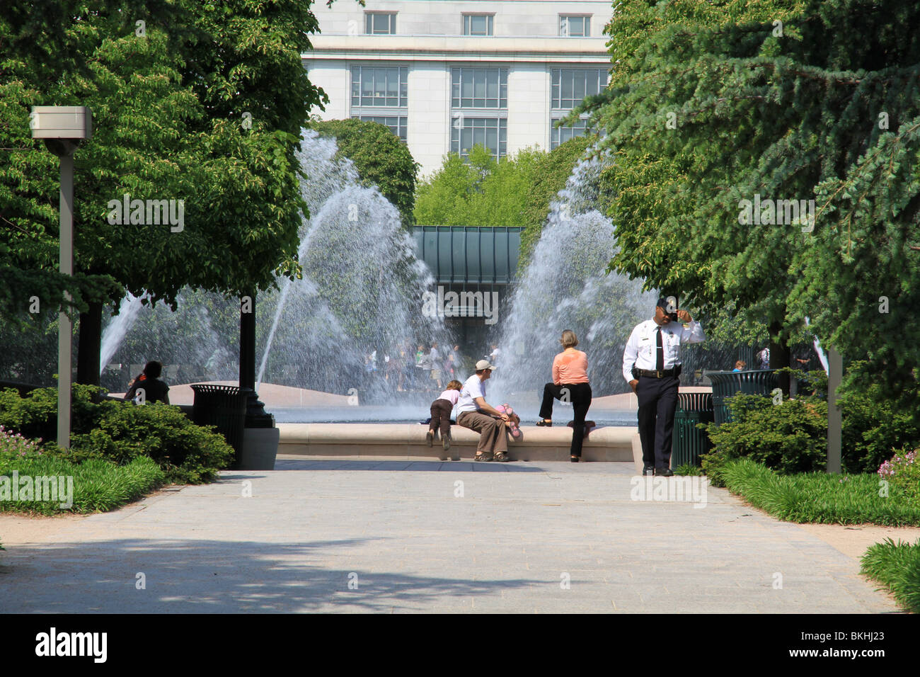 Visitors rest by the fountain pool of The National Gallery of Art Sculpture Garden in Washington, DC Stock Photo