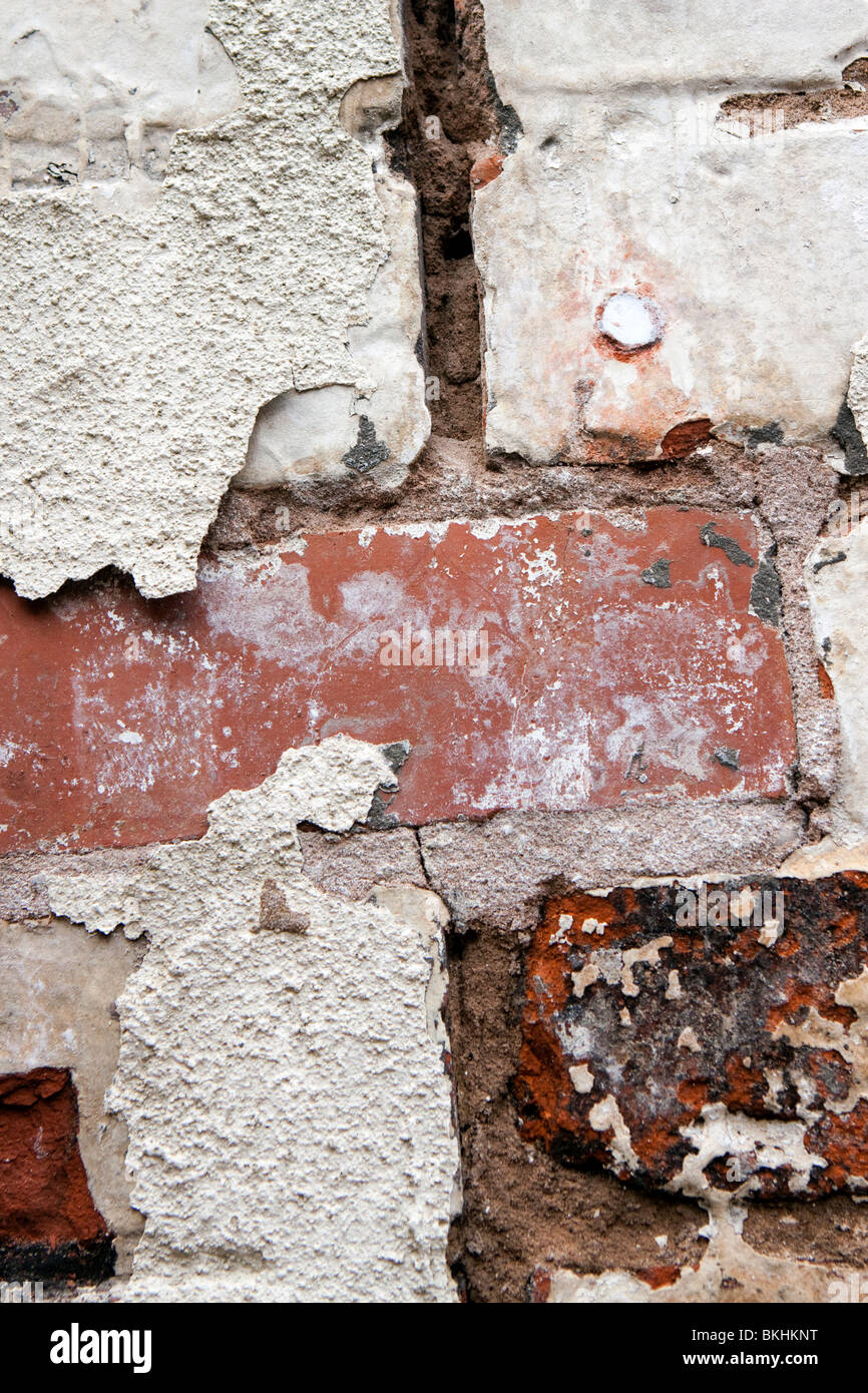 house maintenance flaking paint on old brickwork in need of repointing