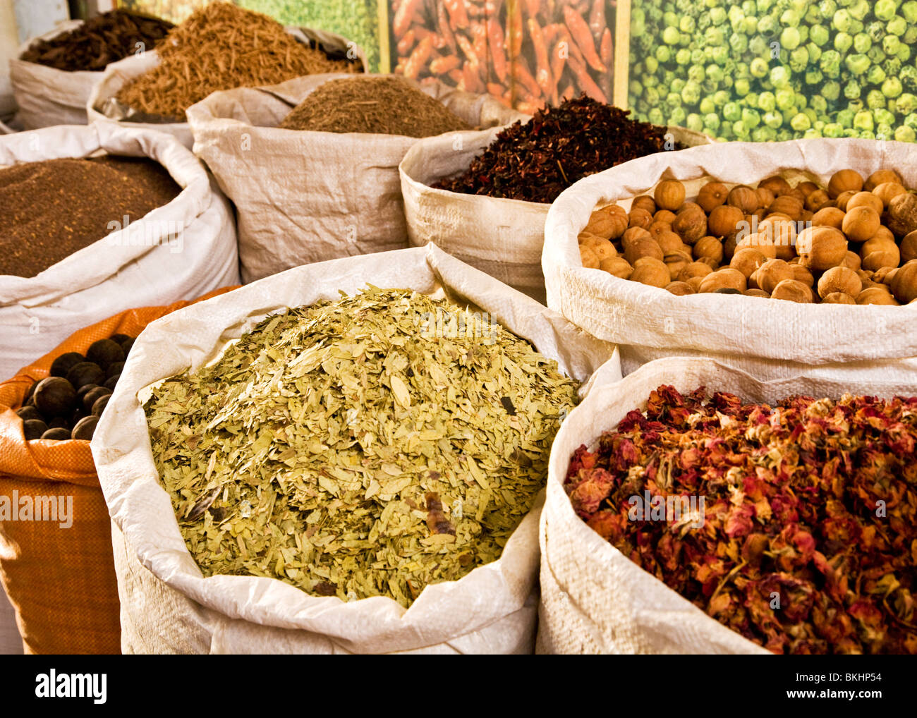 Arabian spices on display in sacks outside a shop in the spice souk in Deira, Dubai, UAE Stock Photo