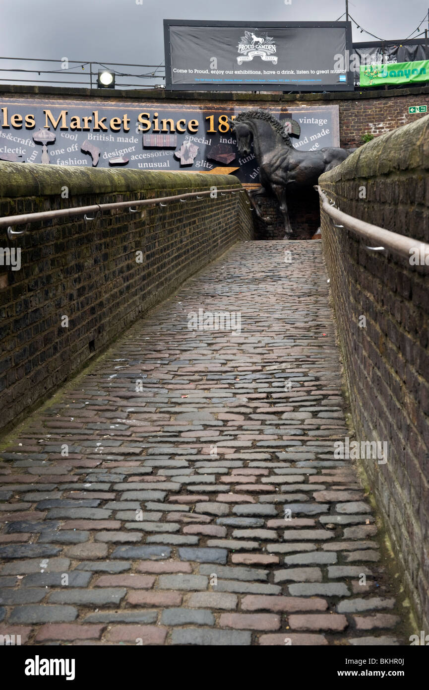 Brick and cobblestone passageway at the Horse Hospital Stables market Camden London UK Stock Photo
