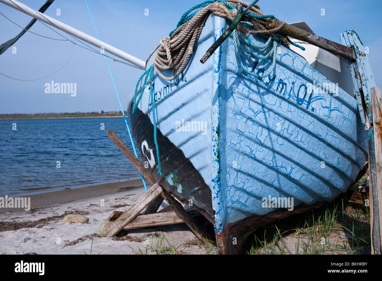 Old disused fishing boat on shore. Denmark, Europe Stock Photo