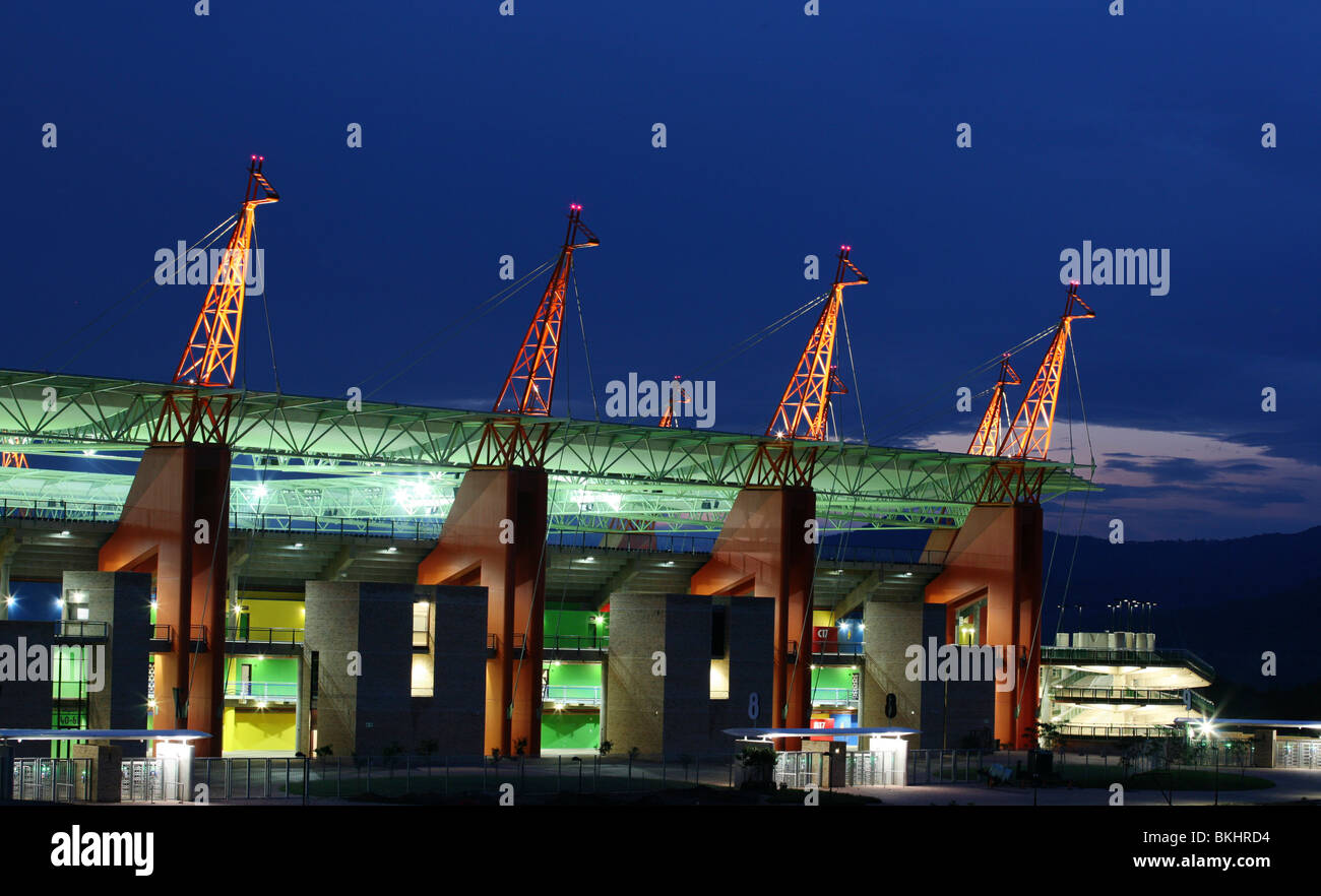 The orange giraffe-like structures of the Mbombela stadium at night Stock Photo