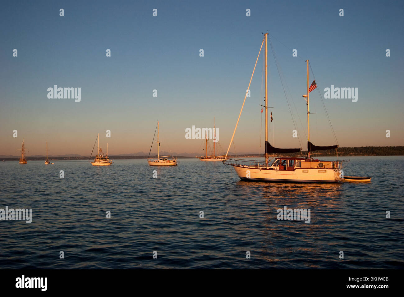 Sailboats at anchor at sunset in Port Townsend Bay, Port Townsend Washington Stock Photo