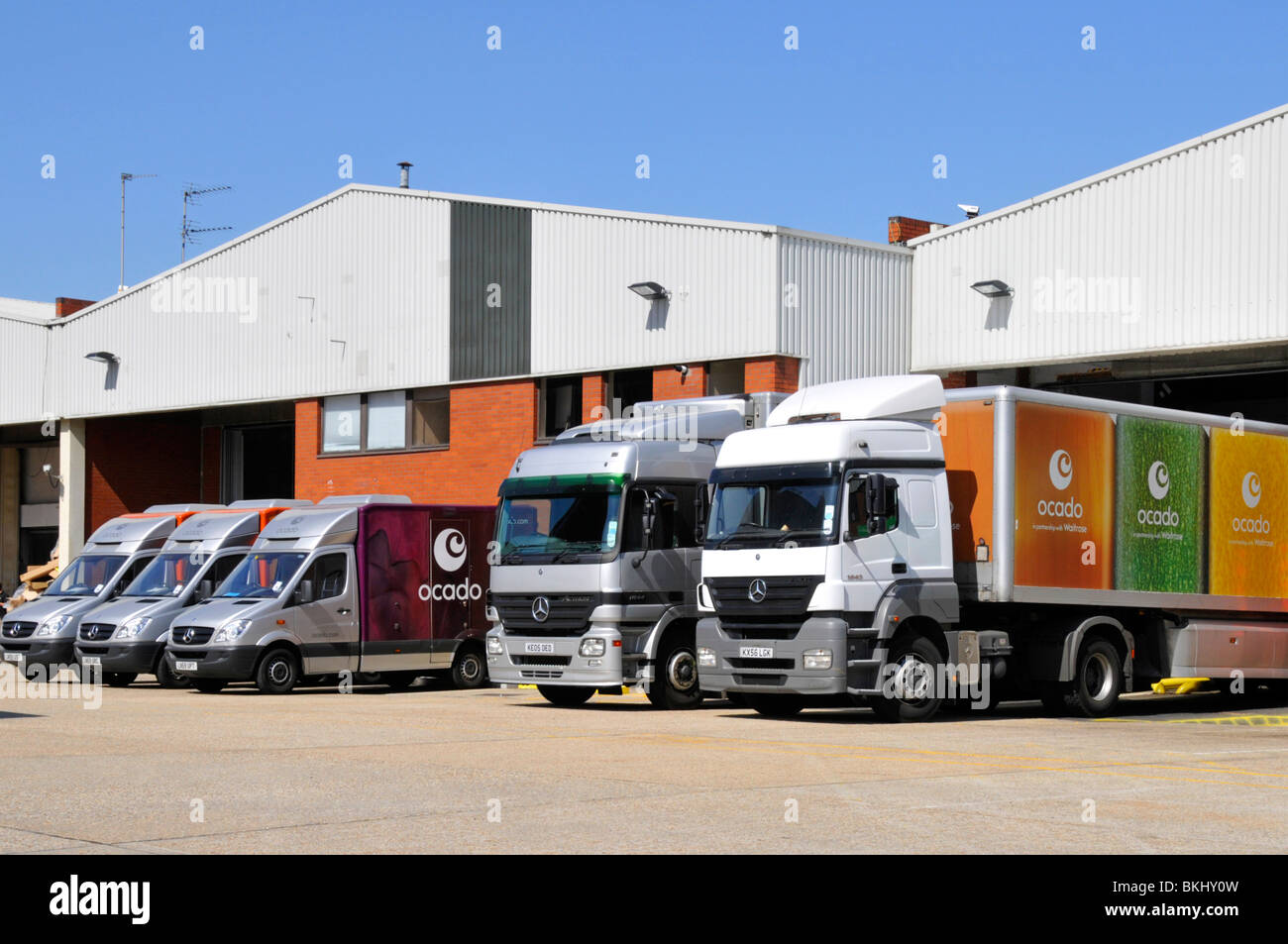 Ocado depot supermarket delivery vans and lorries Stock Photo Alamy