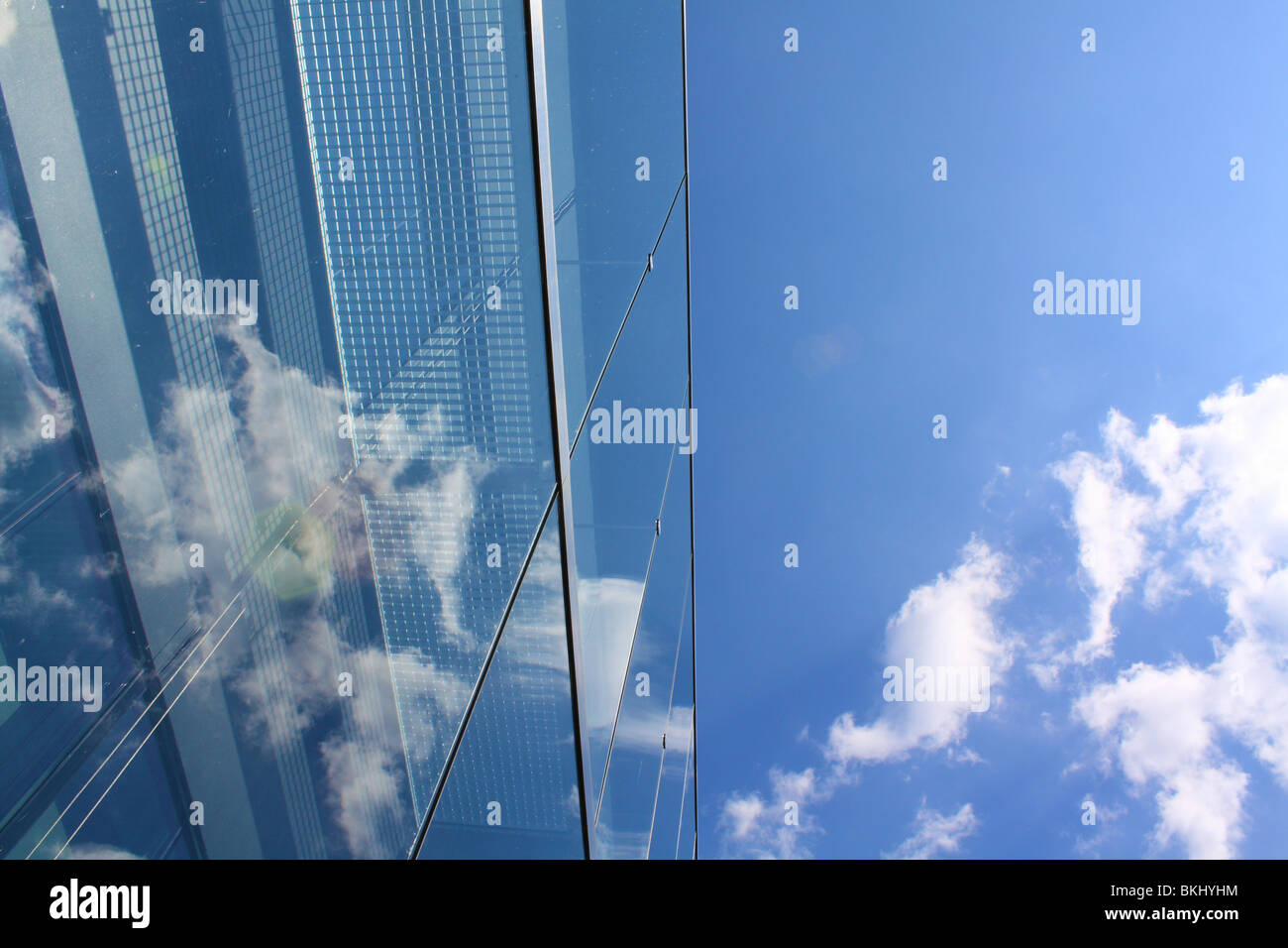 Modern glass office building reflecting the clouds Stock Photo - Alamy