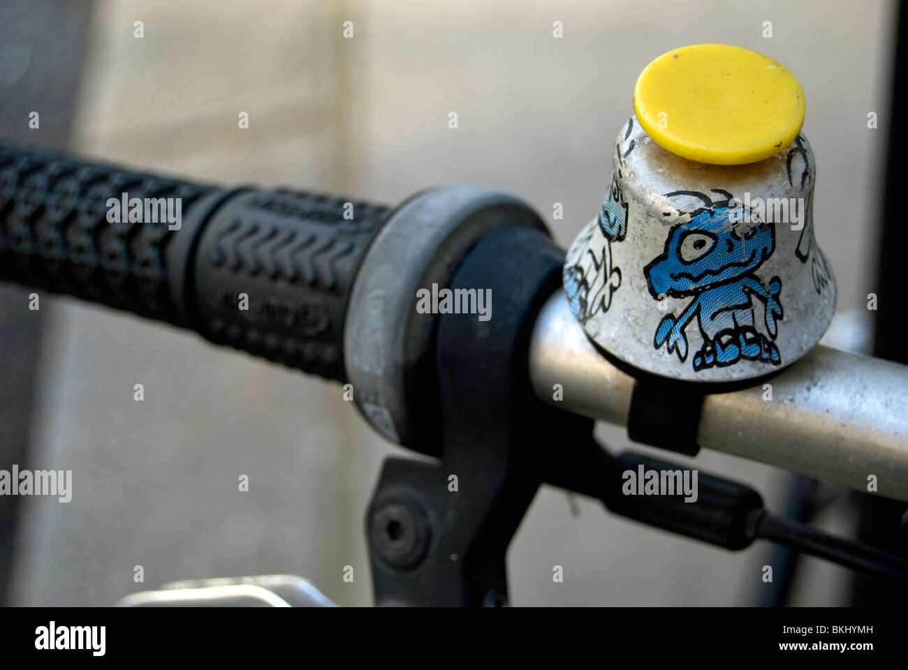 bike bell with pushbutton and cartoon chcracter images, seen on a parked bicycle in london, england Stock Photo