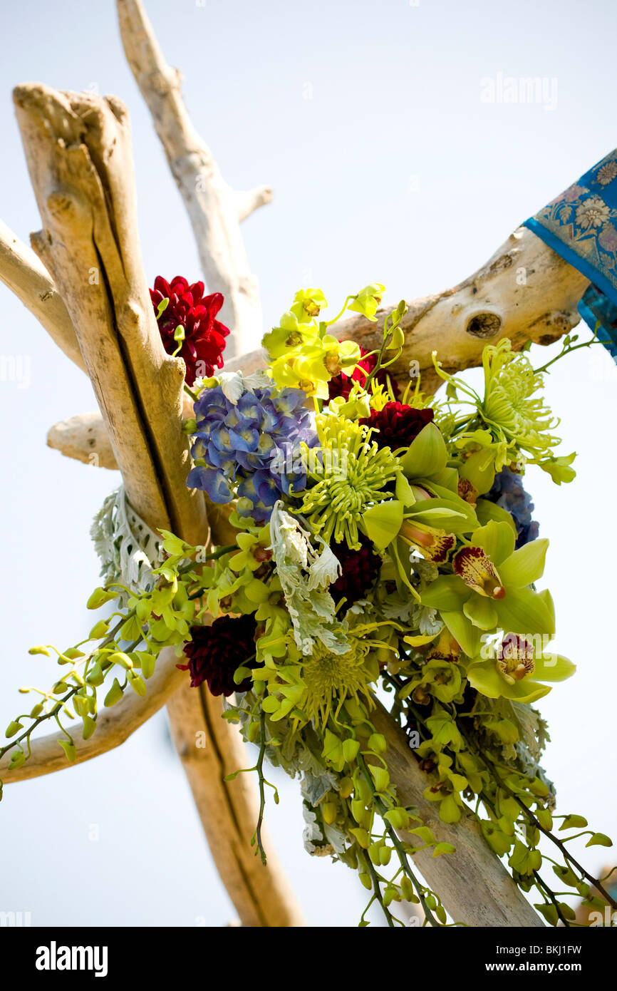 Ceremony, flowers, red, green, blue, color, orchids, natural, wood, alter, outdoor ceremony arch Stock Photo