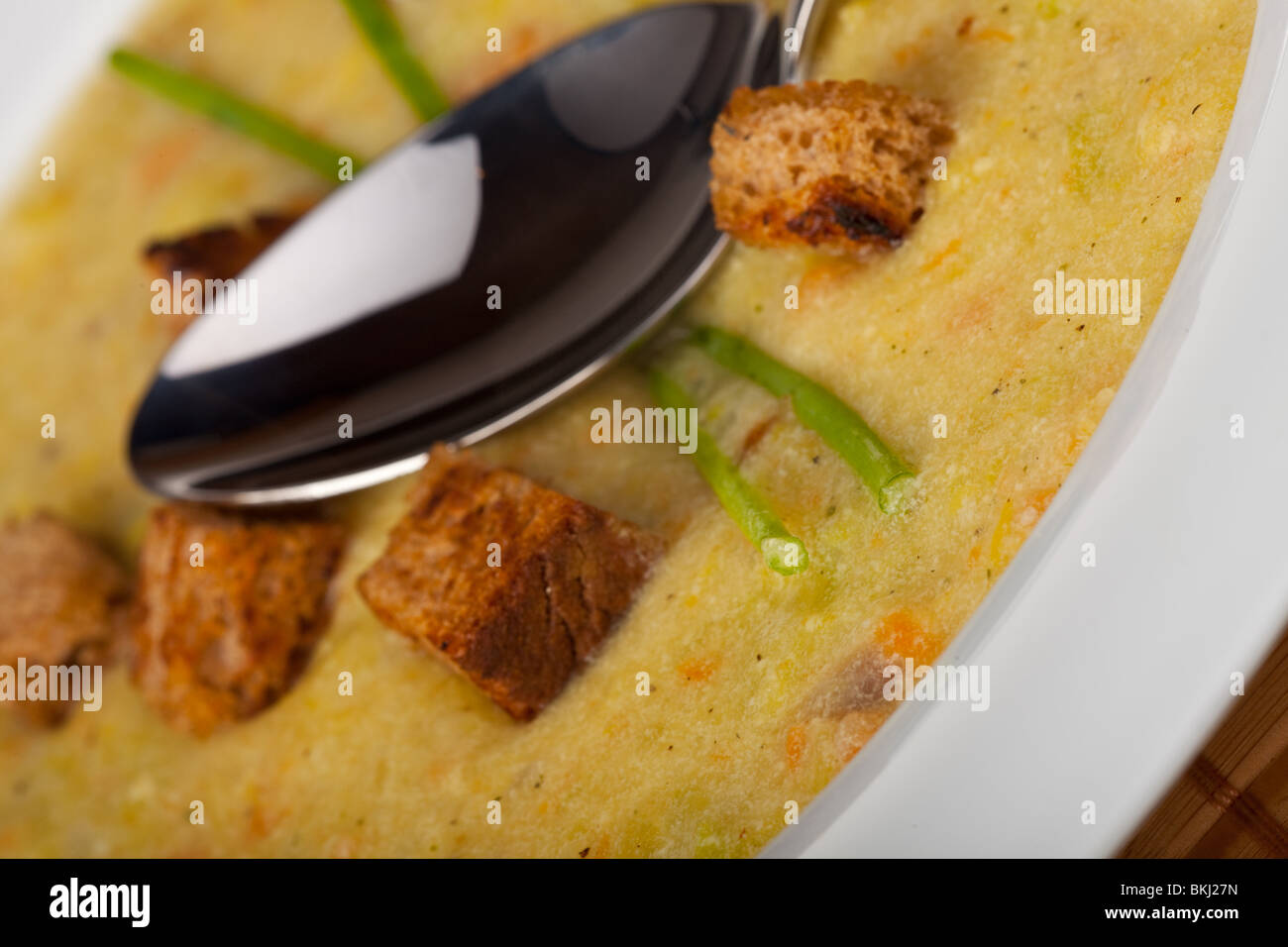 potato soup with croutons and chive strands Stock Photo