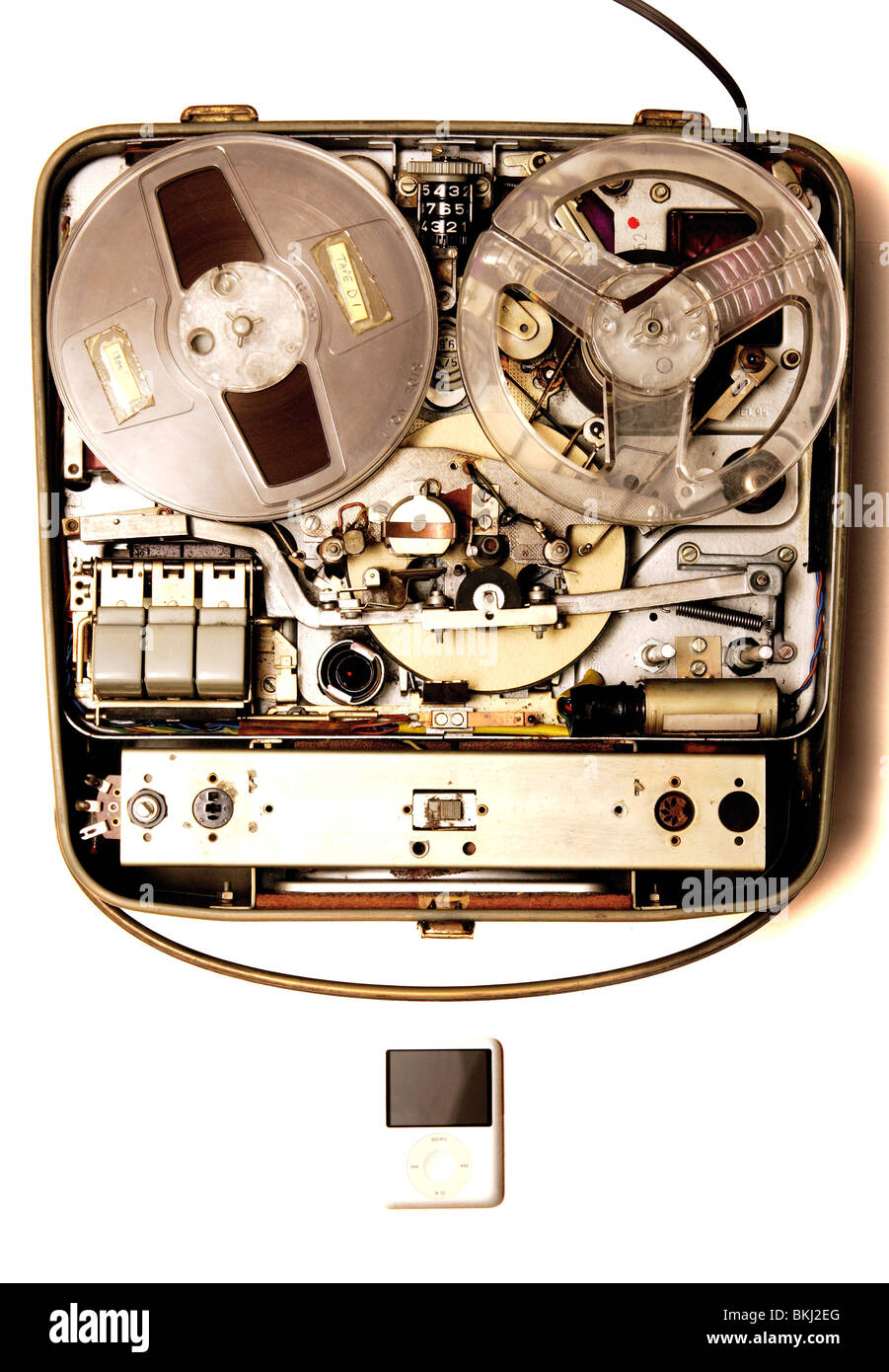 Old fashioned reel to reel tape recorder next to an ipod mp3