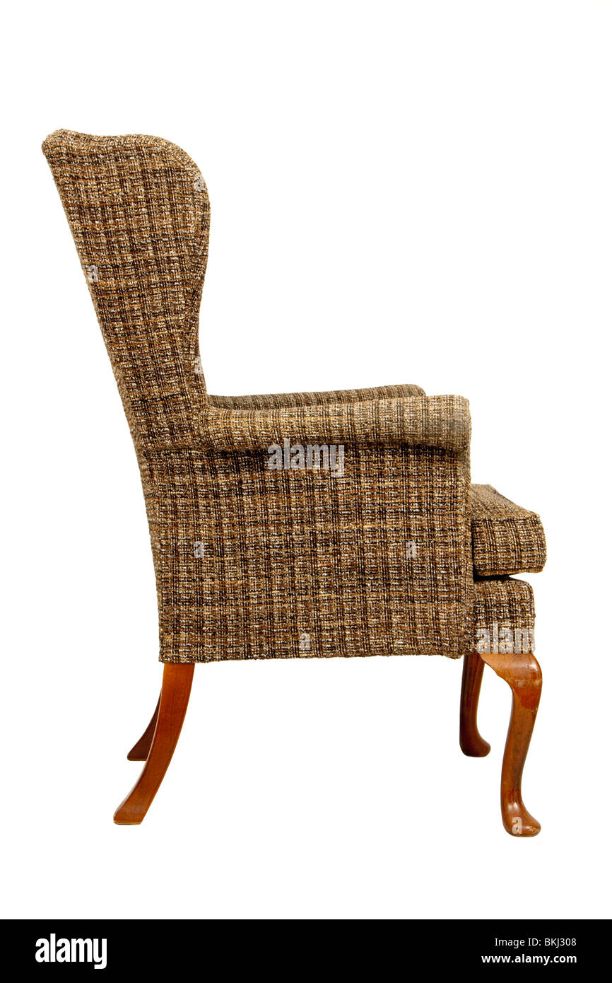 Side view of antique Parker Knoll PK1140 wing back easy chair with chequered upholstery, isolated on white background Stock Photo