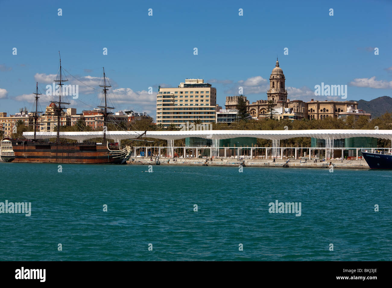 Replica of the Santisima Trinidad warship and Malaga Cathedral. Harbor in Malaga. Andalusia. Spain. Stock Photo