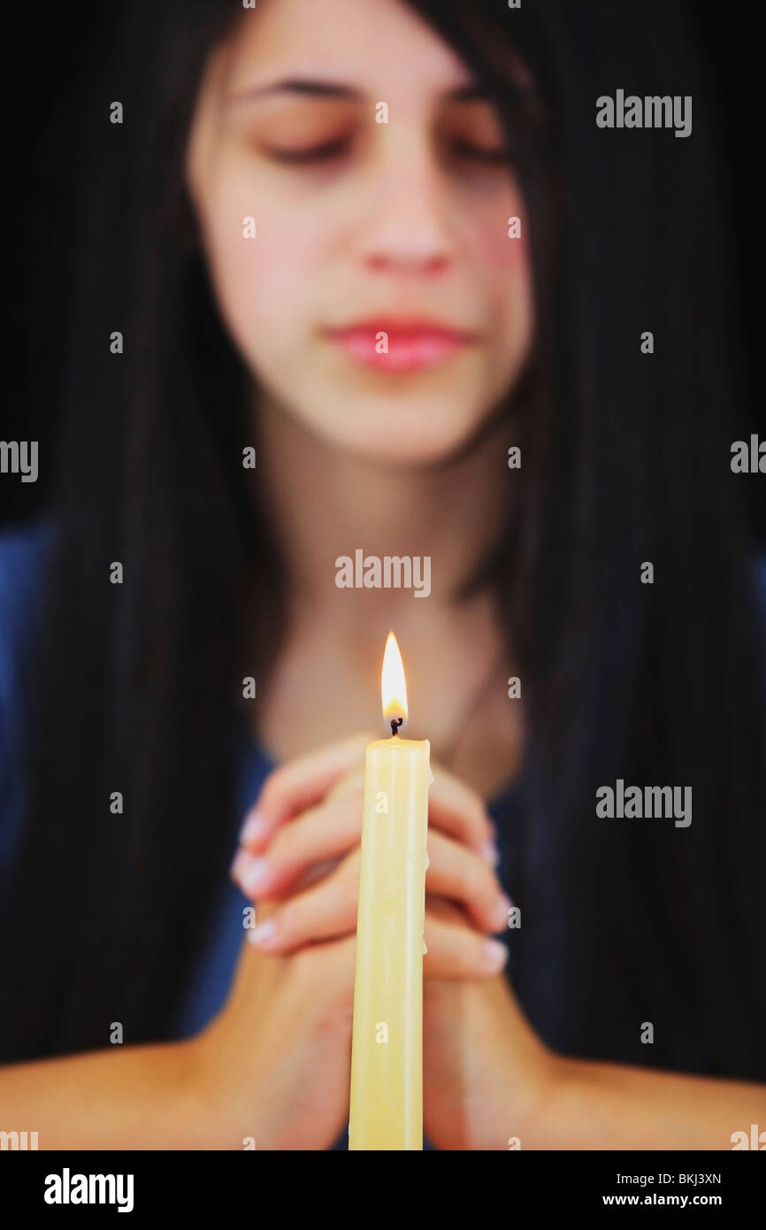 A Teenage Girl Praying With A Candle Lit Stock Photo Alamy