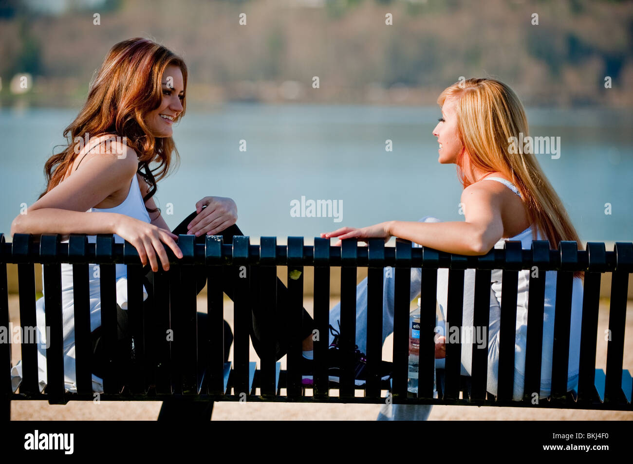 Two young Caucasian women taking a break from their workout outside Stock Photo