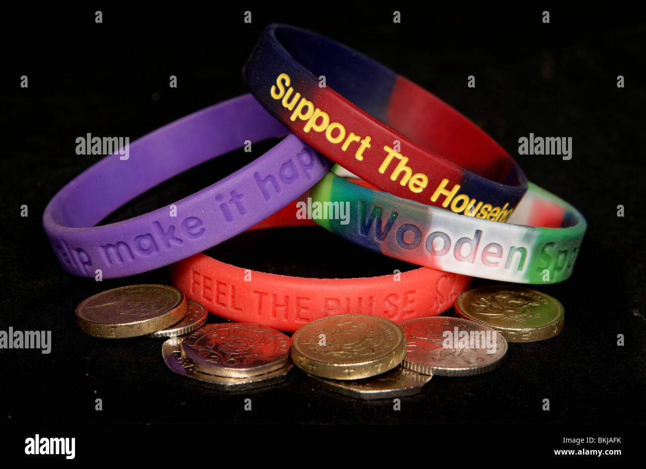 Various charity wristbands with money studio cutout Stock Photo Alamy