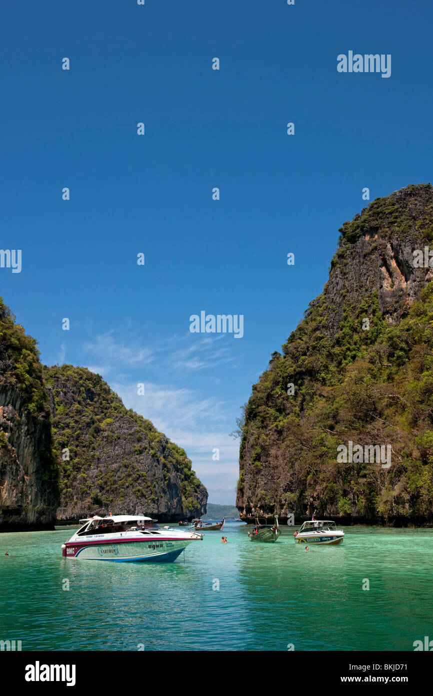 Speedboats moored in a lagoon formed off an island in the Andaman Sea in Thailand Stock Photo