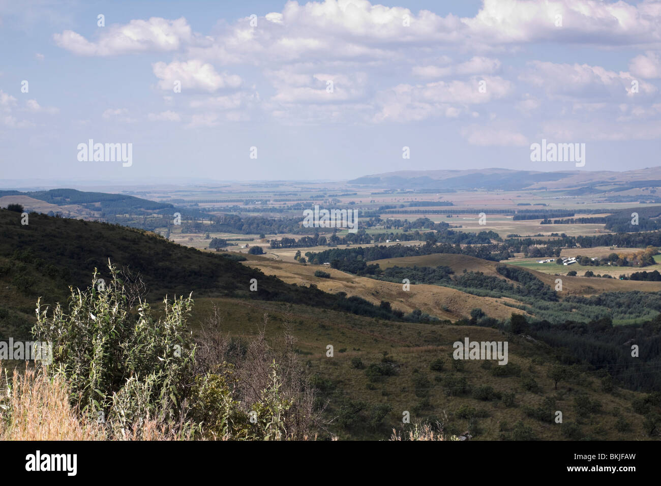 Distant farmlands in the foothills of the Drakensberg, Midlands, KwaZulu Natal, South Africa. Stock Photo