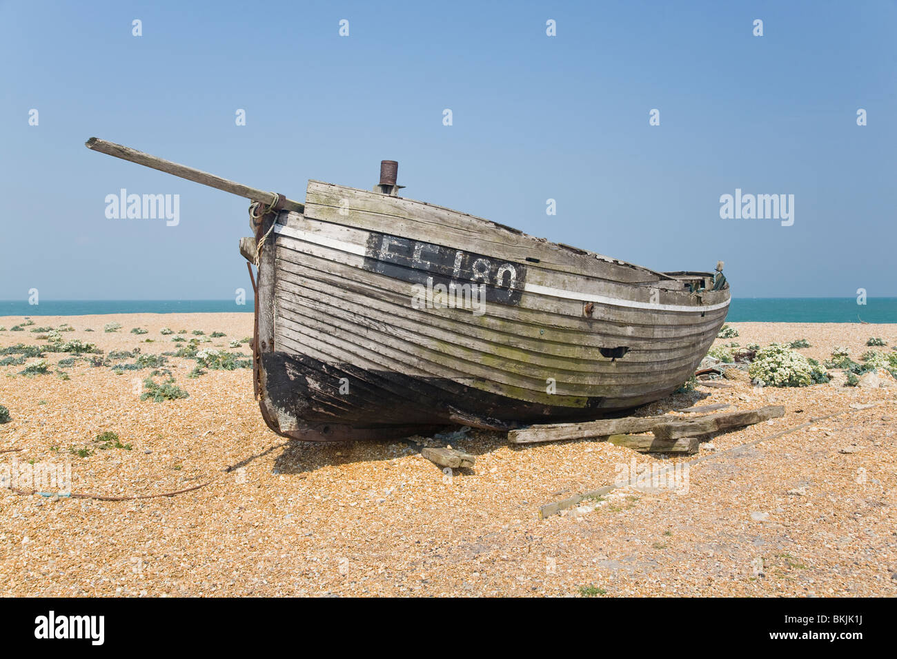 abandoned wrecked fishing boat and engines on the shingle beach in ...