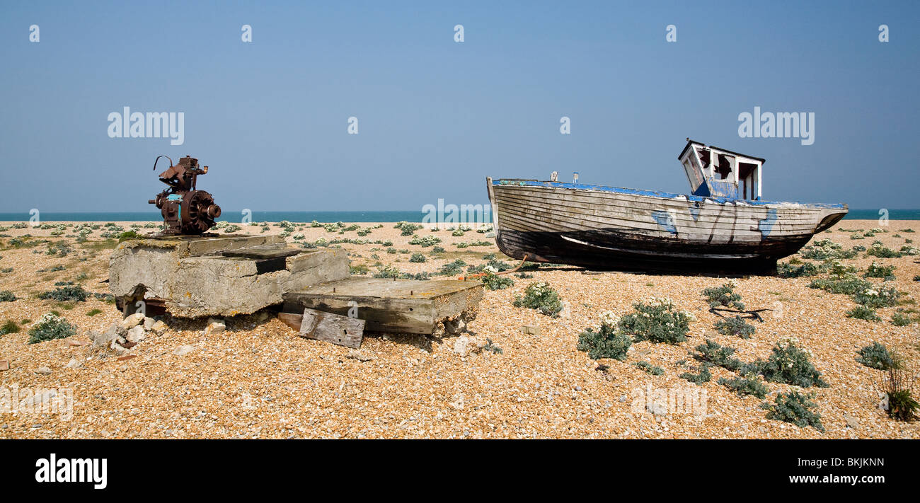 abandoned wrecked fishing boat and engines on the shingle beach in ...